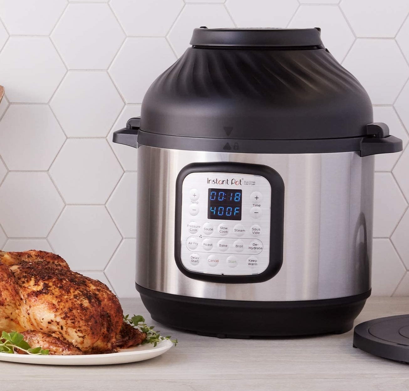 An InstantPot next to a cooked chicken