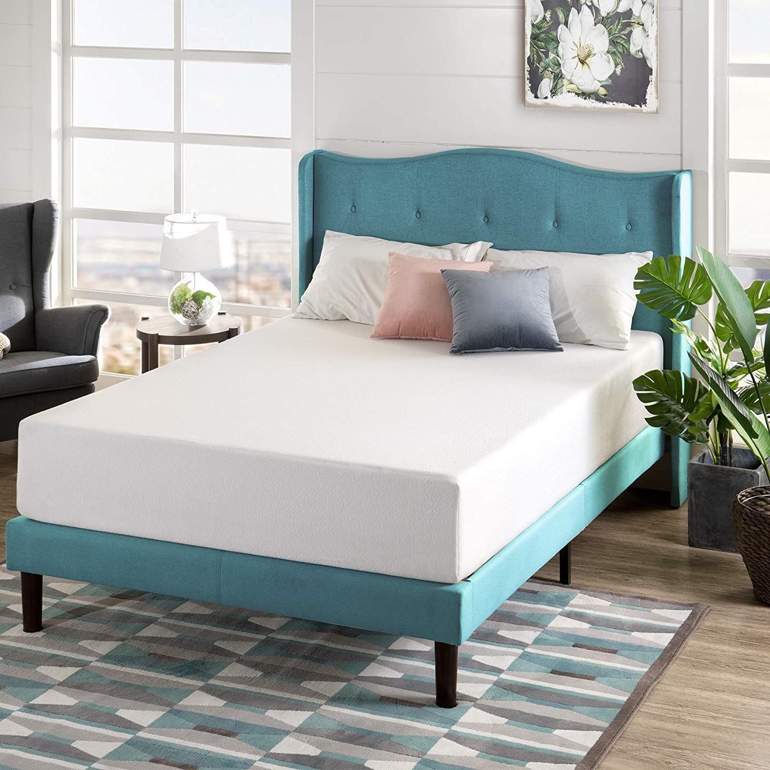 A mattress on a bedframe with pillows on top