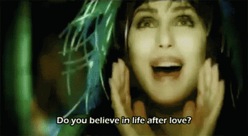A GIF of Cher singing &quot;Do you believe in life after life?&quot; from the music video for Believe 