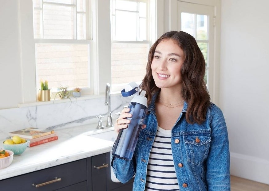 Model holding the water bottle