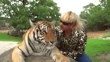 Joe Exotic playing with a tiger.
