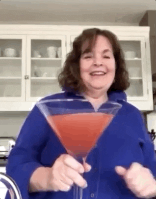 Ina Garten at home with a giant cocktail saying &quot;stay safe, have a very good time, and don&#x27;t forget the cocktails.&quot;
