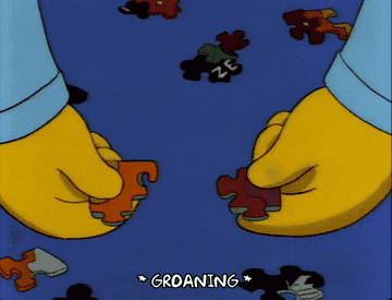 Bart groaning as he tries to fit two puzzle pieces together.