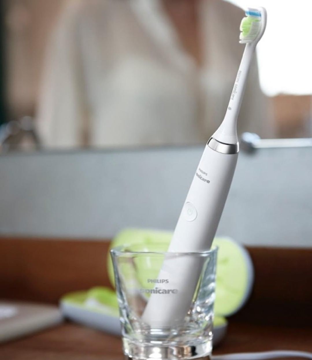 The toothbrush in its charging glass