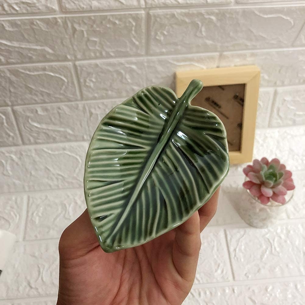 Leaf shaped trinket dish about the size of a hand 