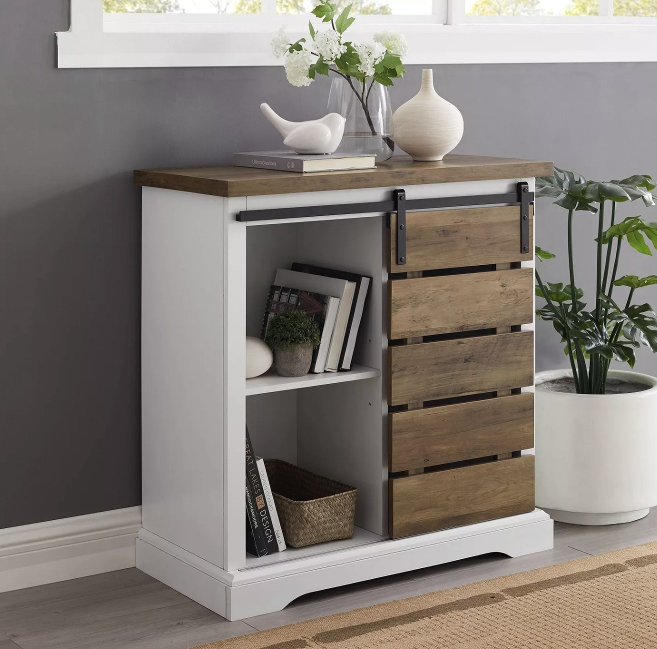 A white buffet table with an oak wood accent sliding door and table top