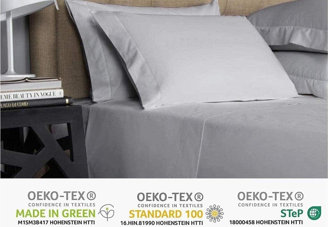 A close up of the smooth sheets on a neatly made bed