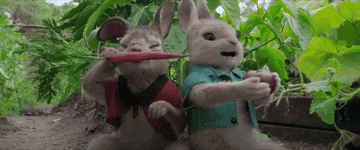 Two animated rabbits, their mouths full of fresh vegetables 