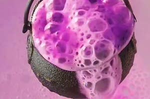 A bubbly purple bath bomb packed into a witch's cauldron