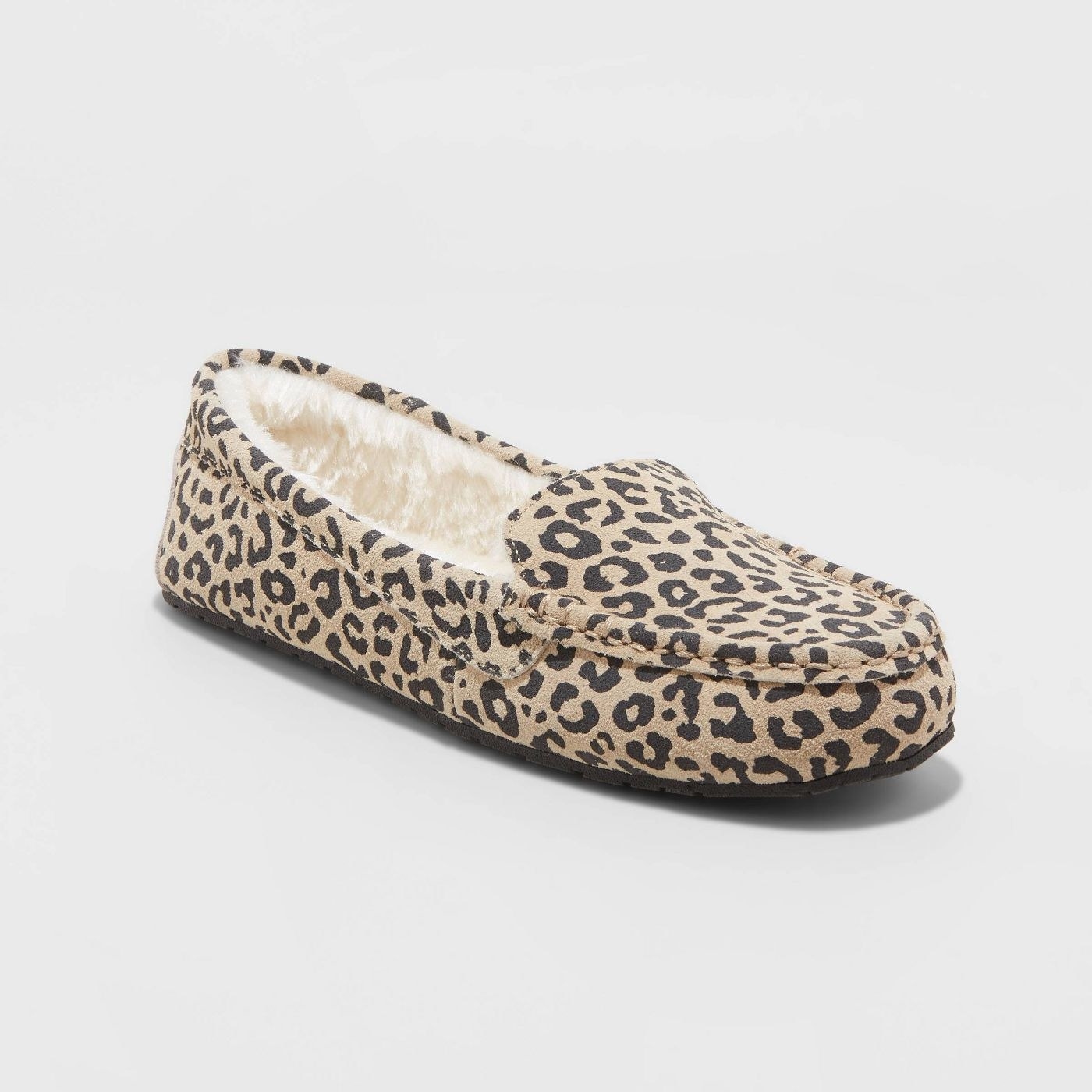 Brown moccasins with black leopard spots and cream-colored lining inside