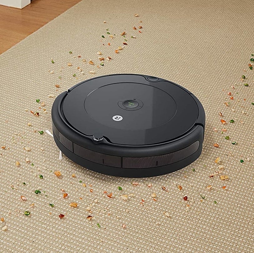 A Roomba cleaning crumbs off a carpet