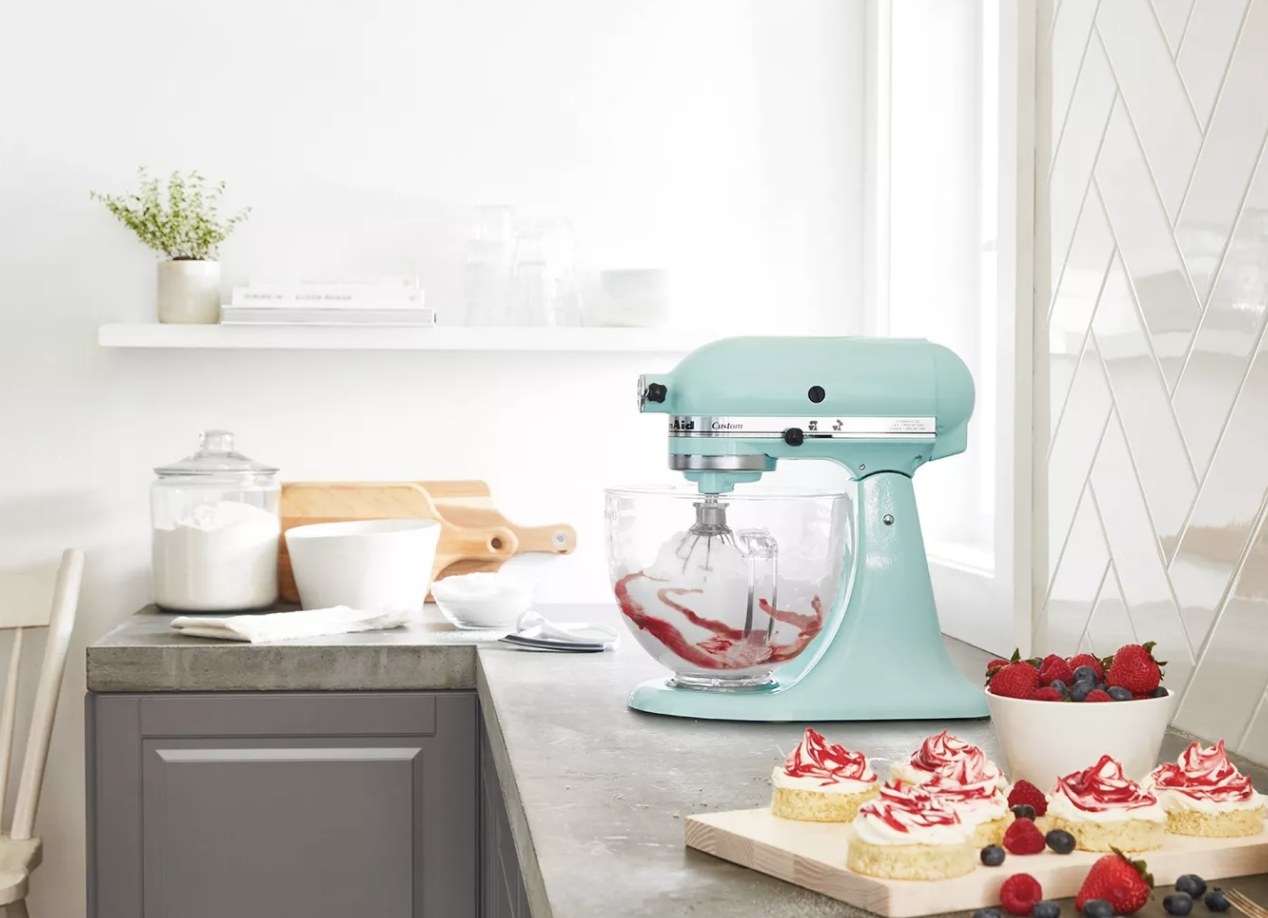 A light blue KitchenAid mixer in a kitchen