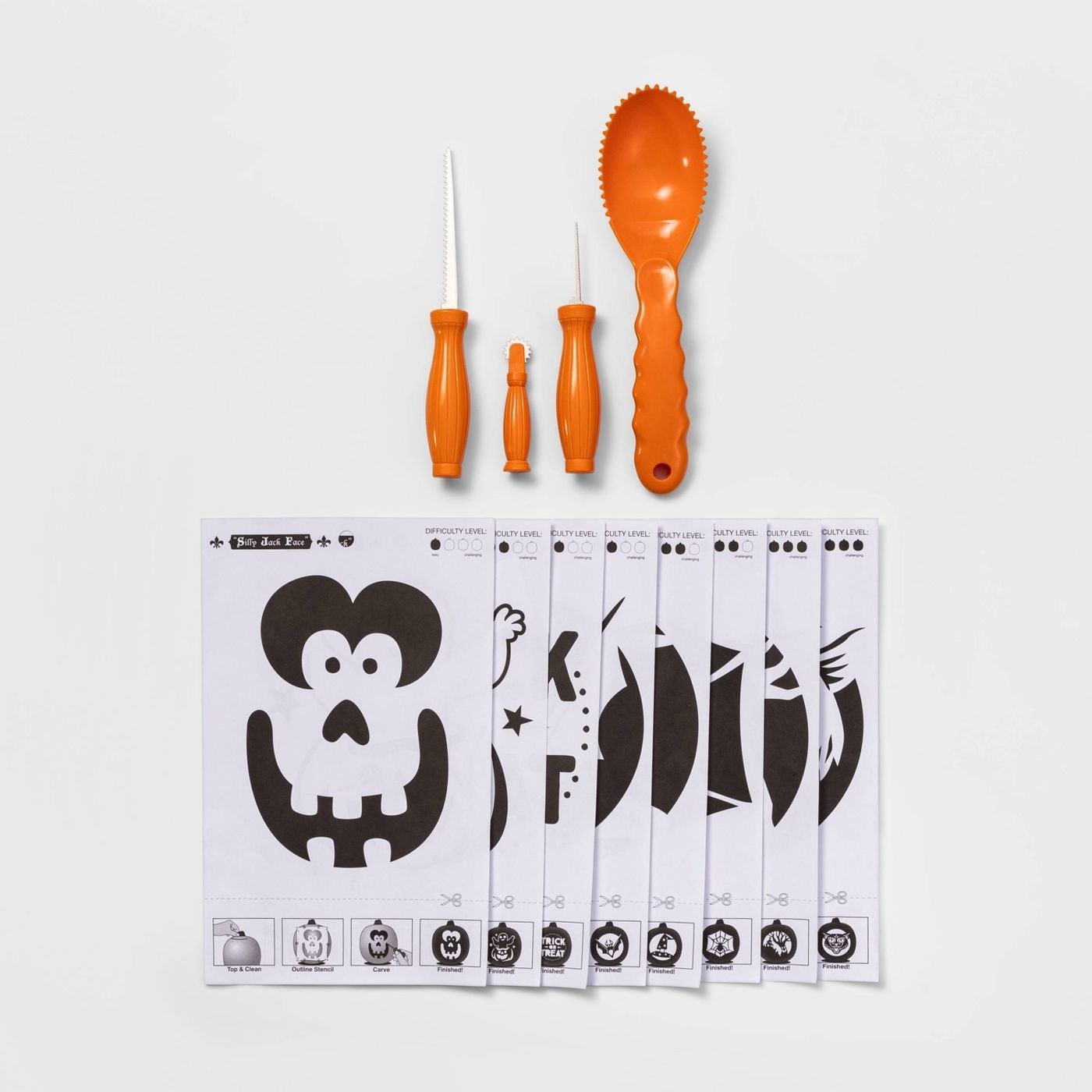 Orange pumpkin carving tools and black and white pumpkin stencils