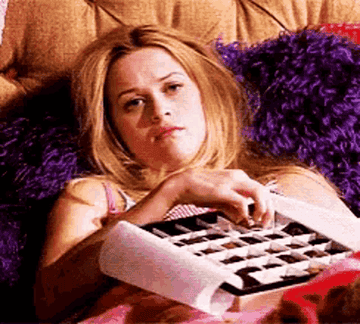 Elle from &quot;Legally Blonde&quot; sadly eats a box of chocolate in bed