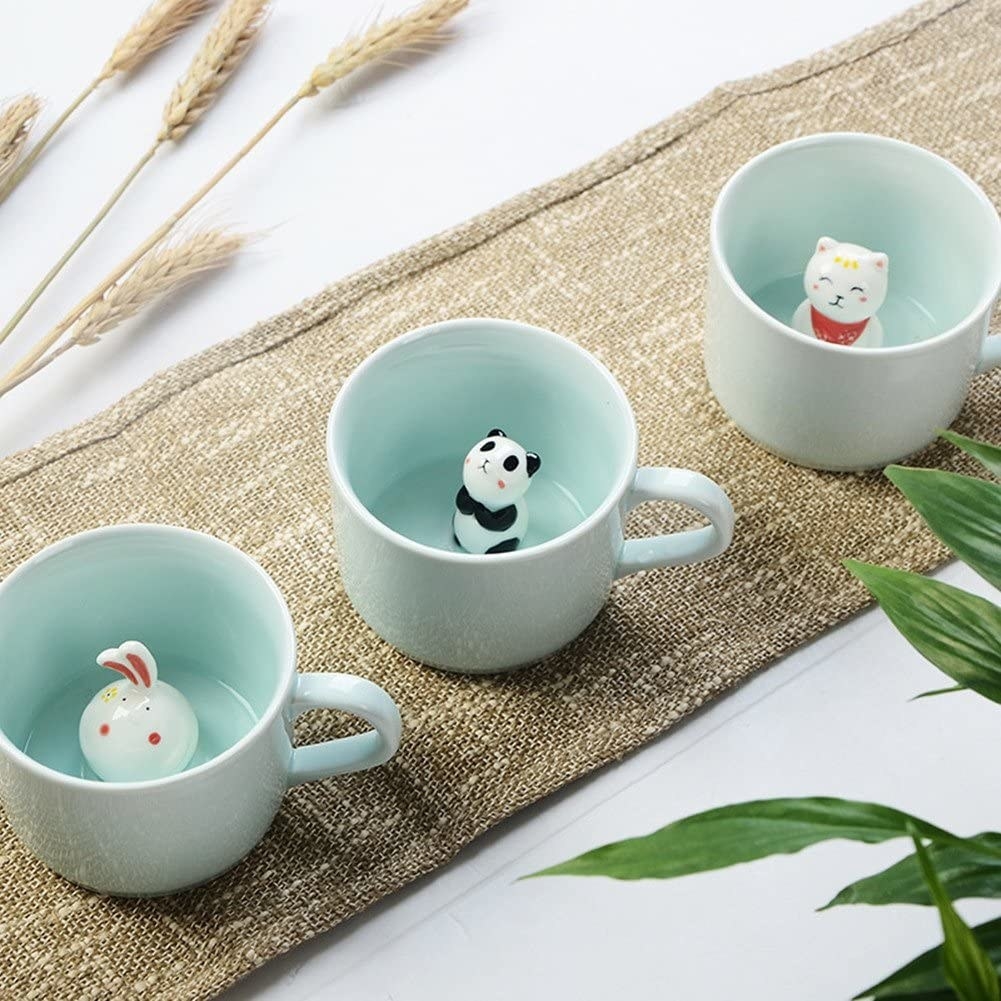 three ceramic mugs with chicken, panda, and cat in them 