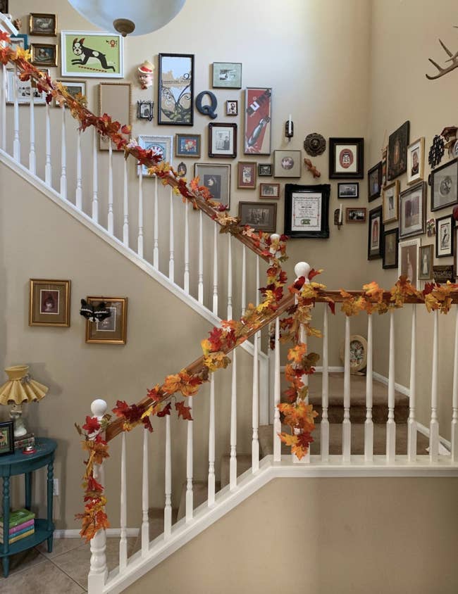 reviewer photo of staircase with leaf garland on banister