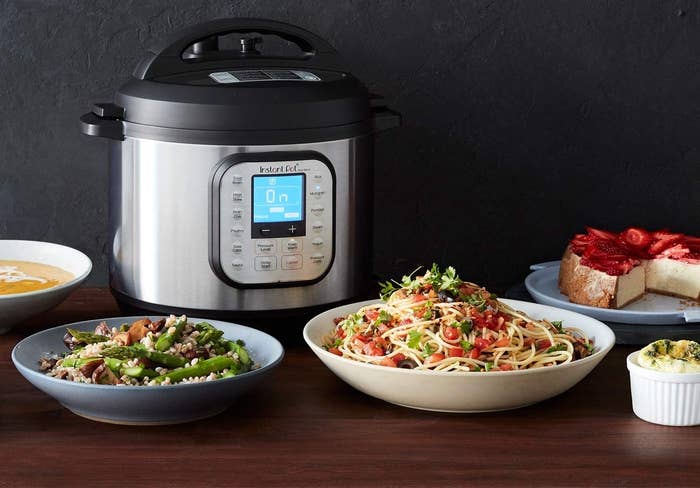 The Instant Pot beside yummy looking food