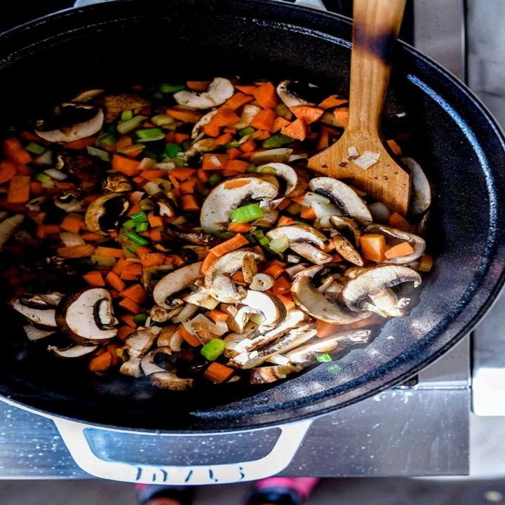 Mushrooms, carrots, and celery cooking in a dutch oven.