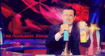 Stephen Colbert spraying disinfectant GIF