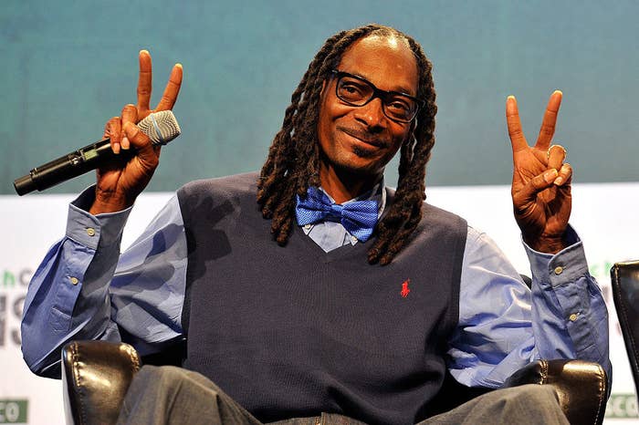Snoop throwing up two peace signs