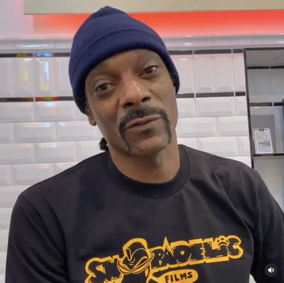 Snoop talking and wearing a beanie