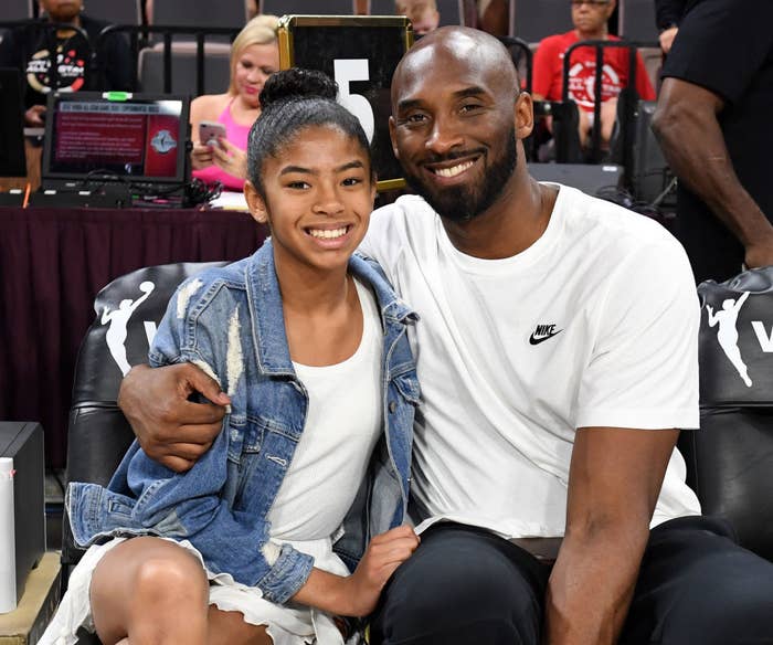 Kobe Bryant smiling and hugging his daughter Gianna