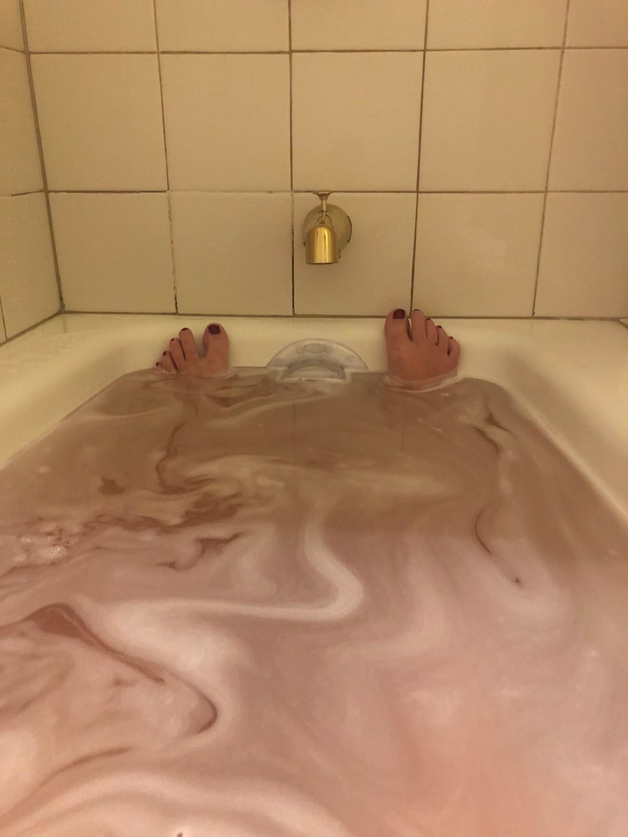 reviewer sits in full tub