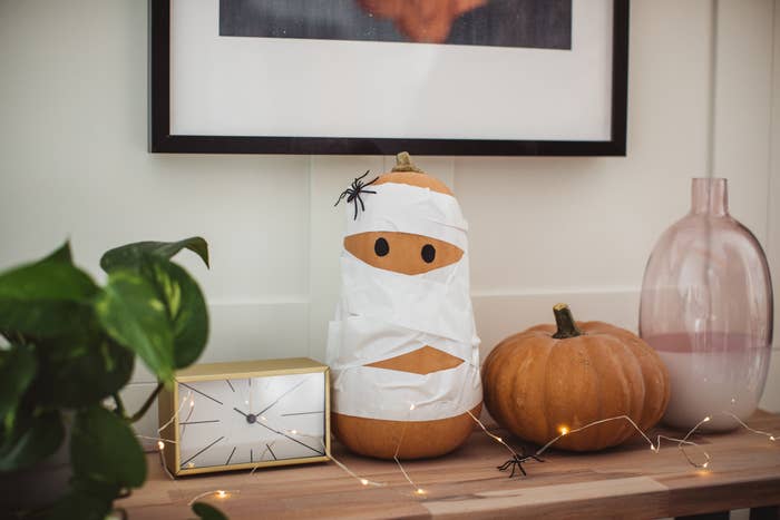 A pumpkin wrapped up like a mummy.