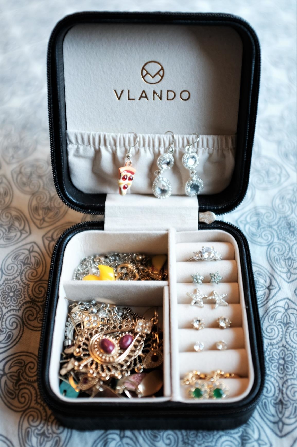 Reviewer pic of the square box filled with an assortment of jewelry
