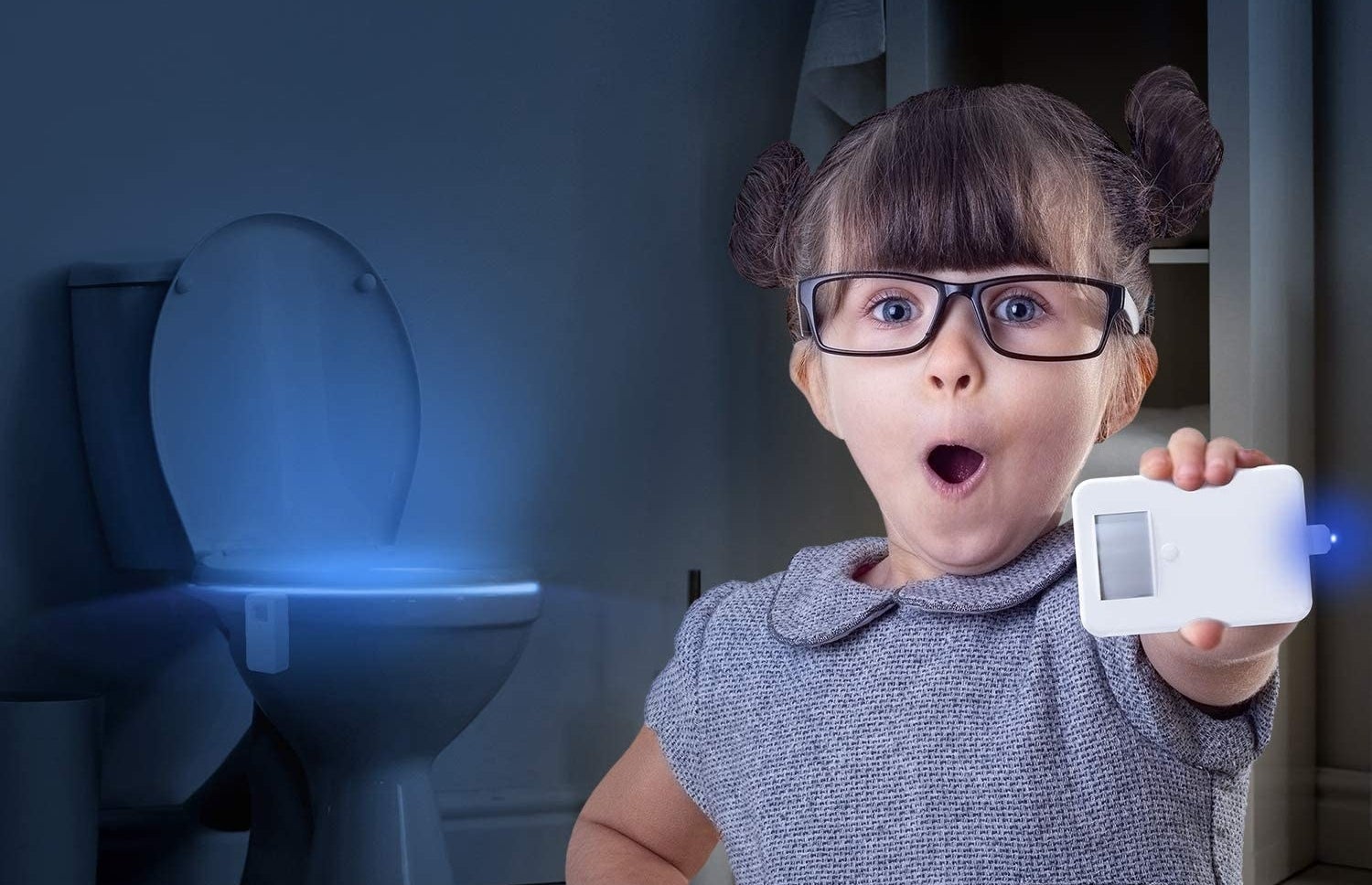 Child model holding toilet light in their hand as blue light glows from toilet