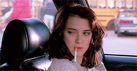 Winona Ryder shales her head with a cigarette hanging out of her mouth