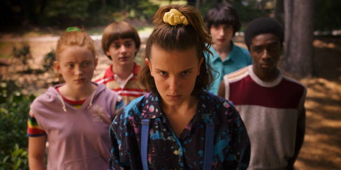 Eleven stands flanked by Max, Will, Mike, and Lucas, looking determined