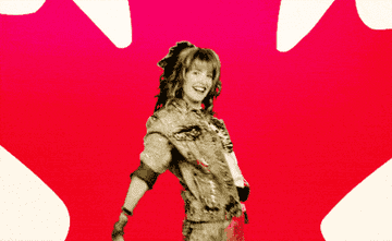 GIF of Robin Sparkles from How I Met Your Mother dancing in front of a maple leaf