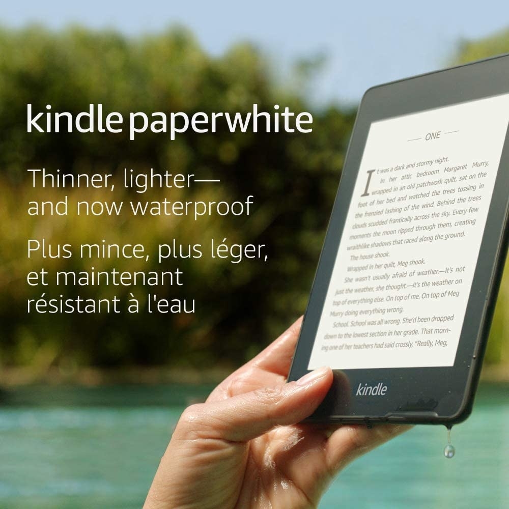 A person holding the Kindle in a swimming pool