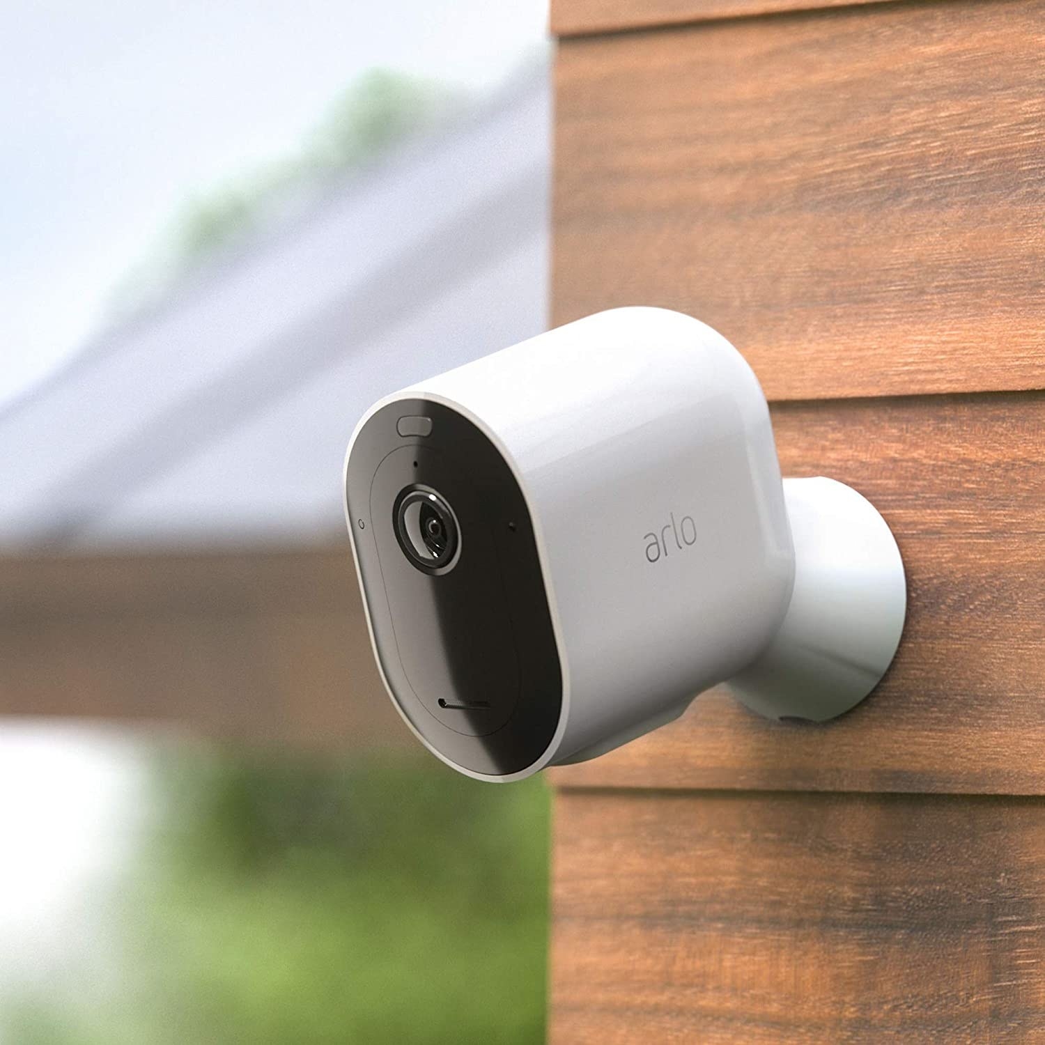 A security camera attached to a wooden wall