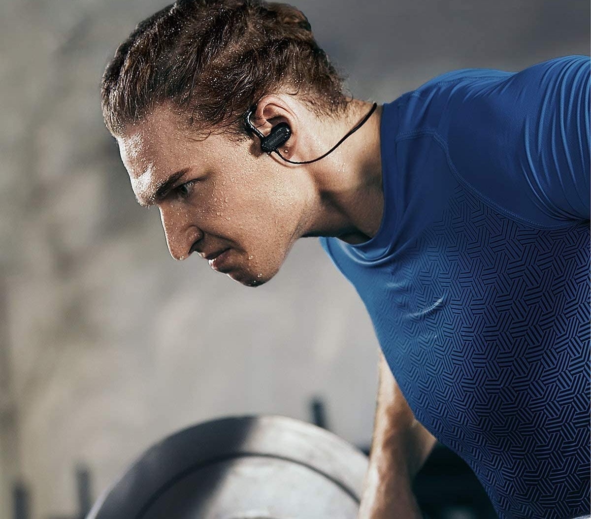 A person working out while wearing wireless headphones