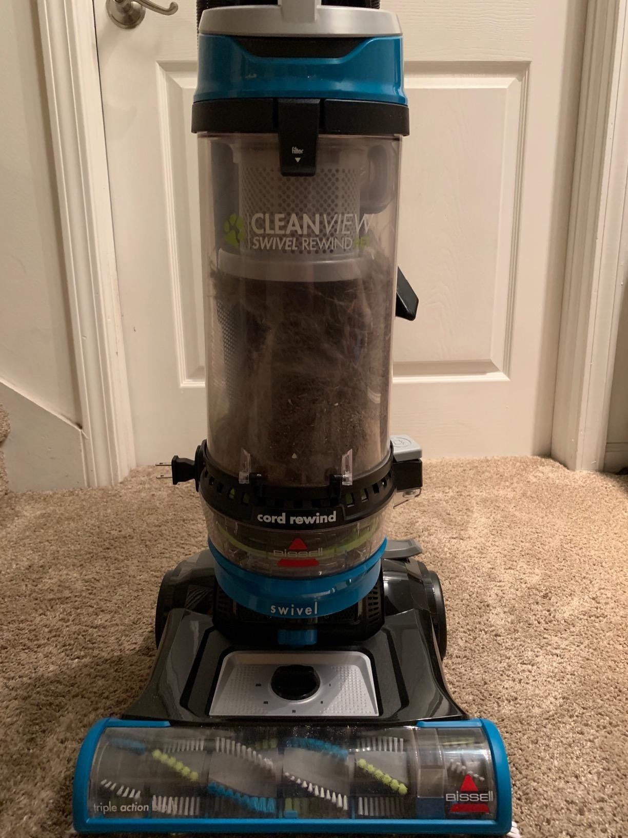 A review image of the vacuum full of picked-up pet hair and dust