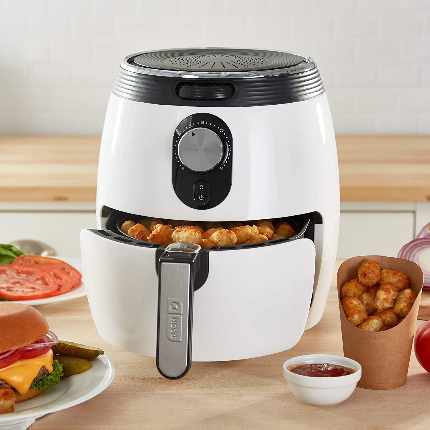 White air fryer with tater tots in the basket 