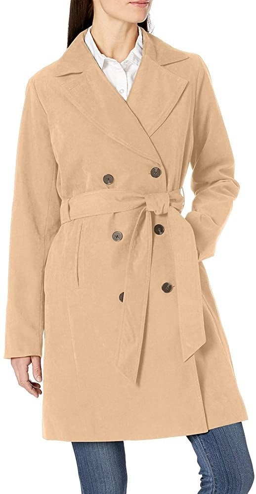 Model in the double-breasted camel trench coat