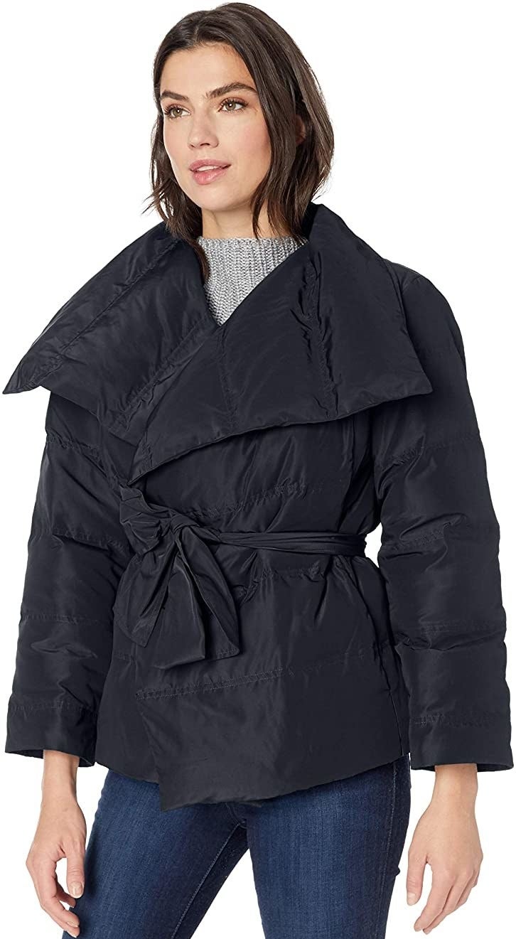 Model in black coat with a tie belt