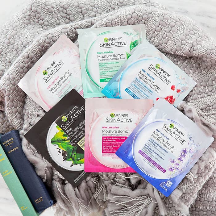 A pile of sheet masks on a blanket