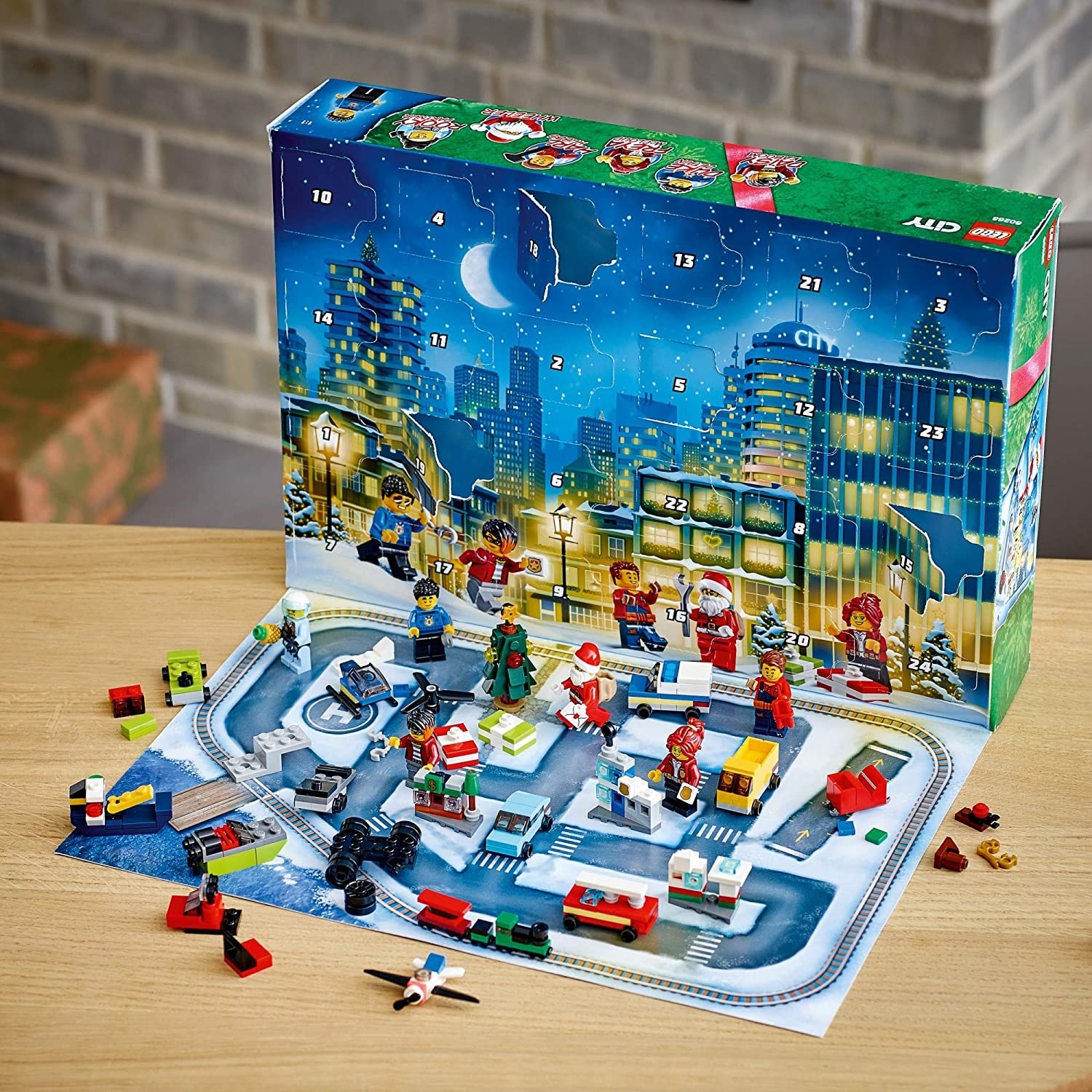 Opened Lego package with a holiday-themed city scene and small toys and figures
