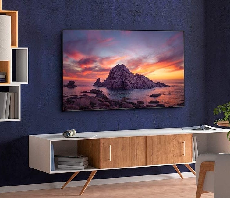 The flat screen smart TV hanging on a wall in a living room
