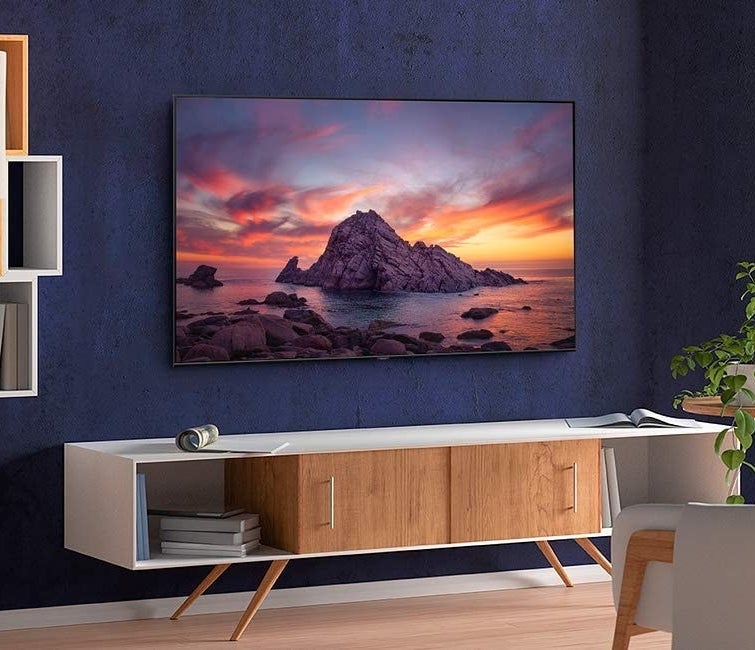 The flat screen smart TV hanging on a wall in a living room