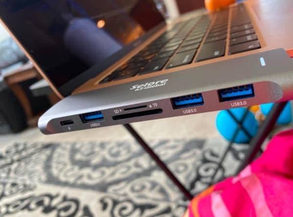 A reviewer photo of the adapter hub connected to their MacBook Pro laptop