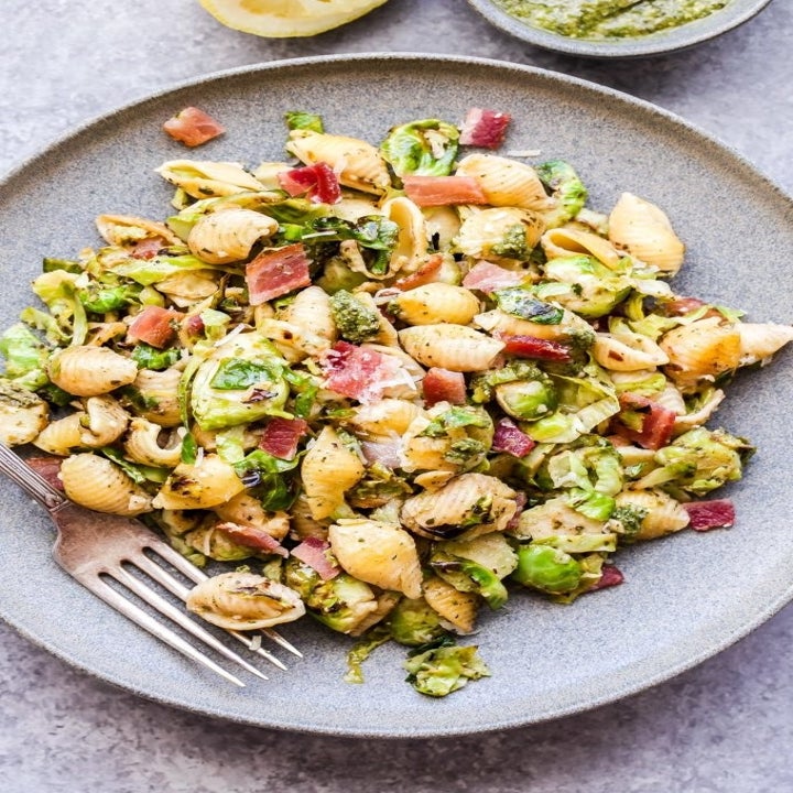 A plate of bacon and Brussels sprouts pesto pasta shells.