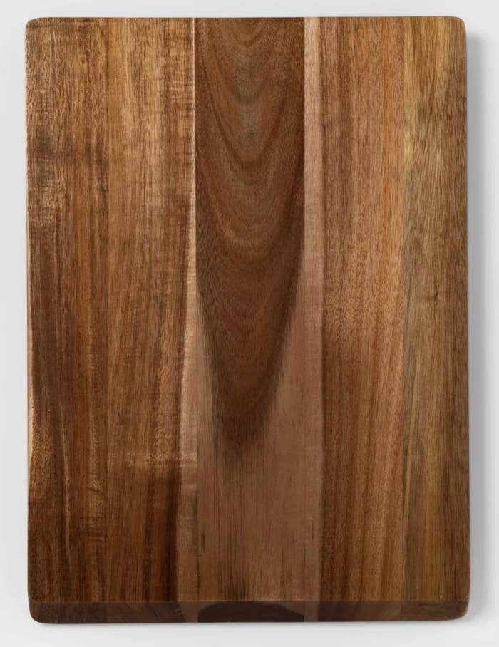 a dark brown cutting board against a grey surface
