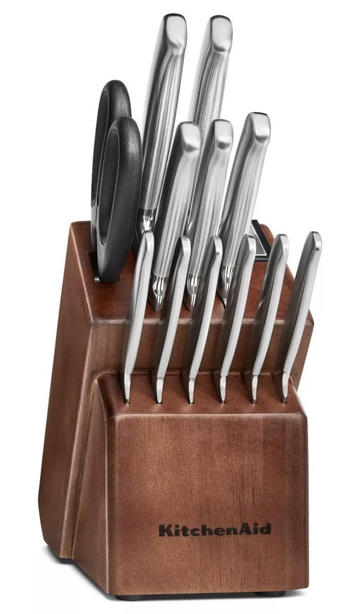 a 14 piece stainless steel knife set in a dark brown vessel