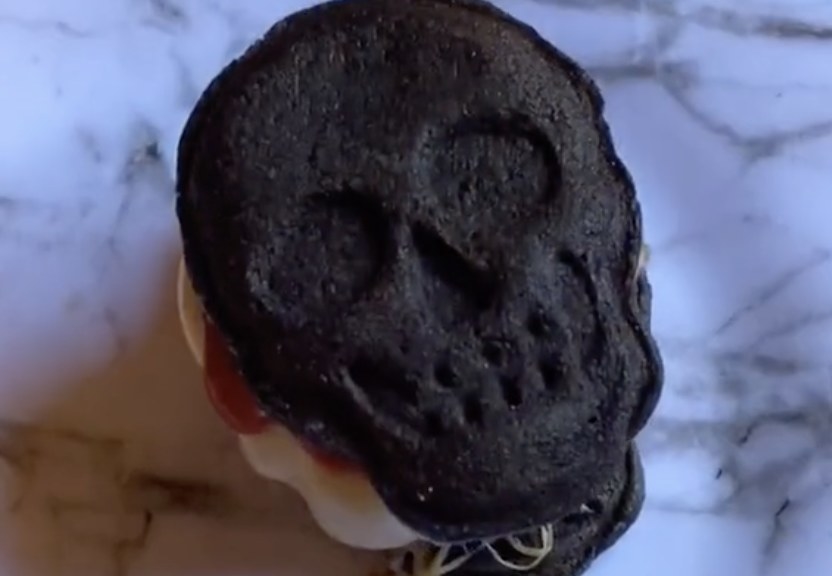 A burger bun that is shaped like a skull 