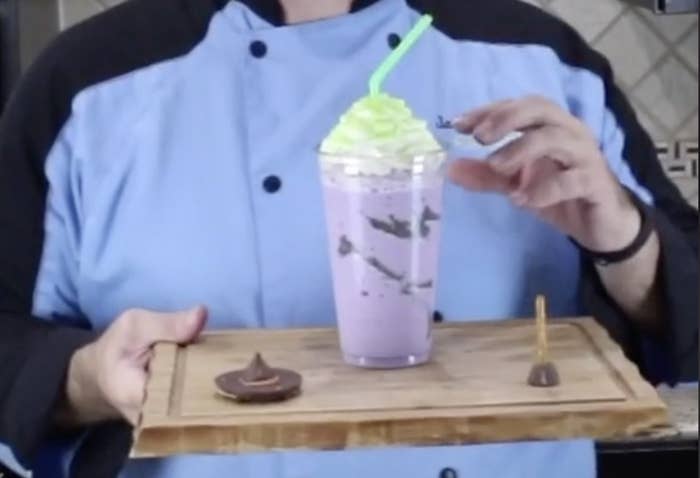 A purple frappuccino with green sprinkles